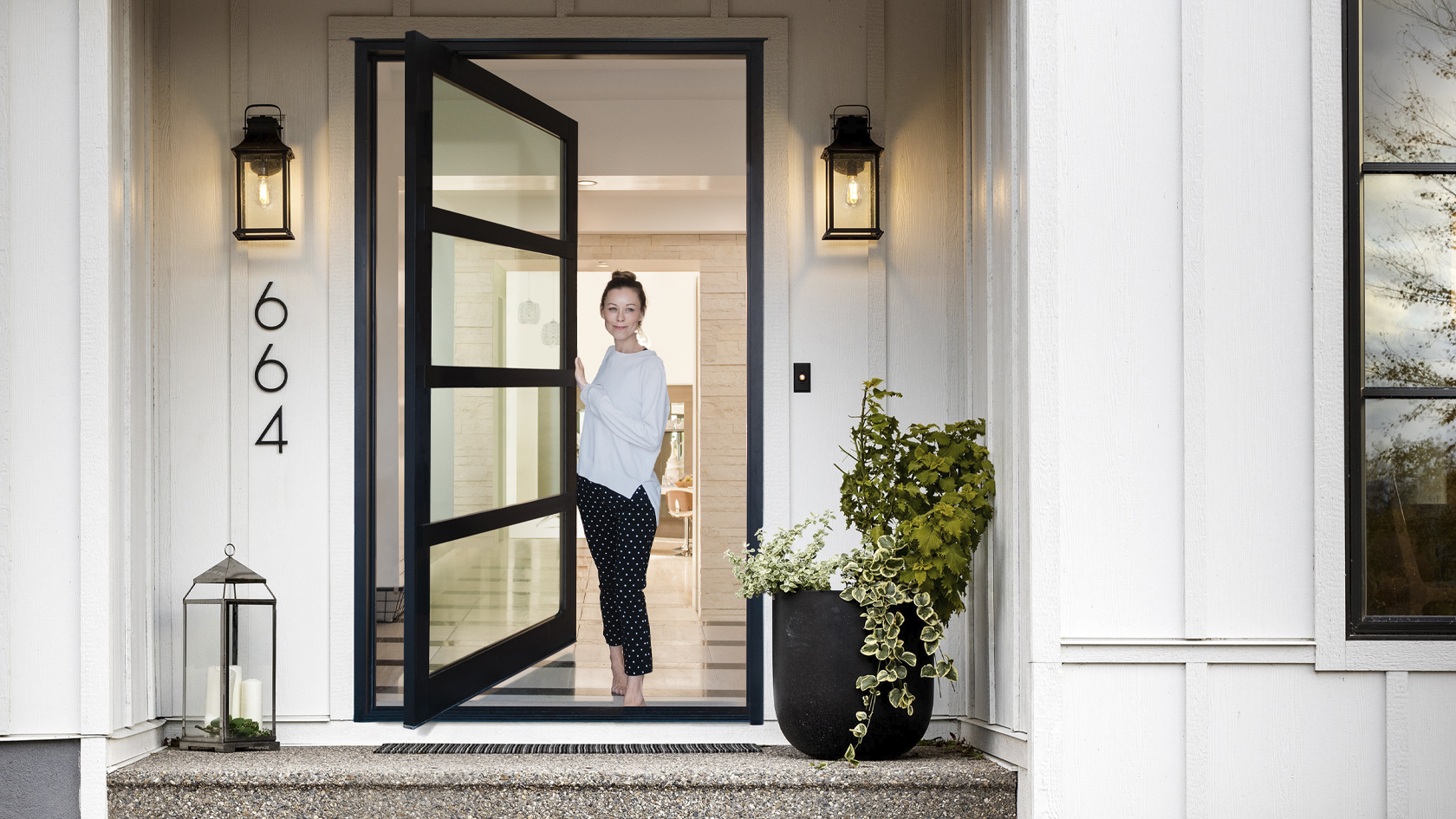 Woman opening her Lux Pivot doorway