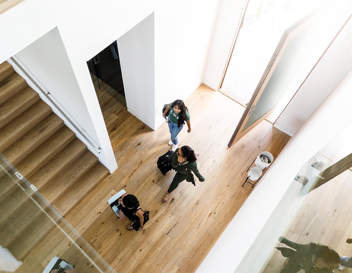 Overhead view of people walking into a house