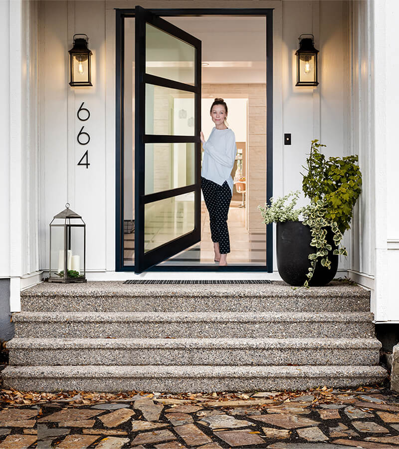 Woman opening her Lux Pivot doorway